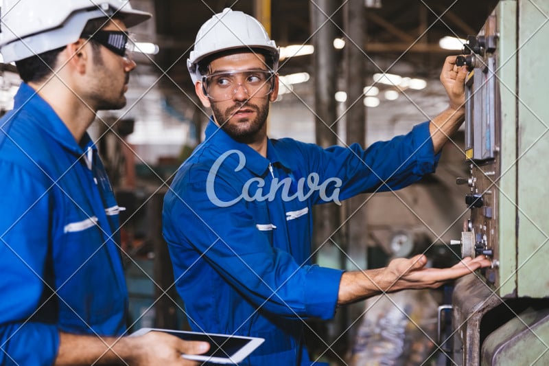 Group of Industrial factory maintenance engineers inspect relay protection system of machinery. Industry, Maintenance, Engineering and construction concept.